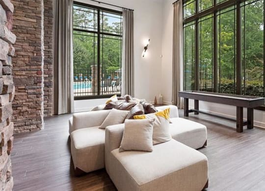 a living room with a couch and a table at Trails at Short Pump Apartments, Virginia