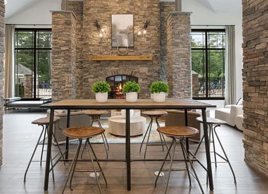 a dining room with a table and chairs and a fireplace in the background at Trails at Short Pump Apartments, Richmond ,23233