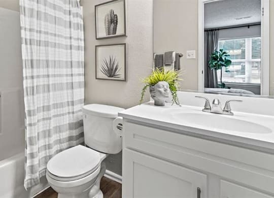 a bathroom with a toilet sink and bathtub at Trails at Short Pump Apartments, Richmond, VA, 23233