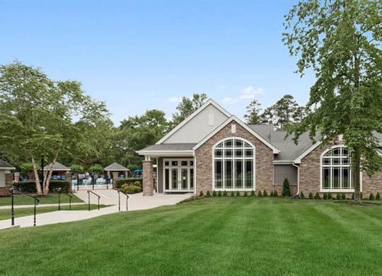 a house with large windows and a green lawn at Trails at Short Pump Apartments, Richmond, VA, 23233