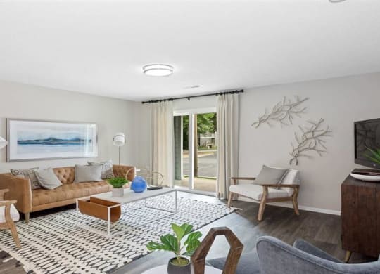 a living room filled with furniture and a flat screen tv at Trails at Short Pump Apartments, Virginia