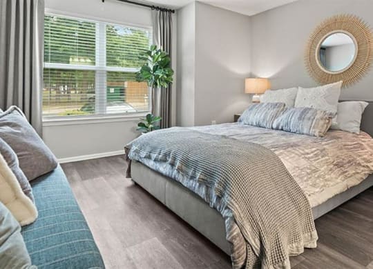 a bedroom with a bed and a large window at Trails at Short Pump Apartments, Richmond ,23233