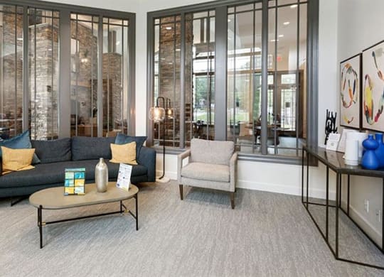 a living room with a couch and two chairs at Trails at Short Pump Apartments, Richmond, VA