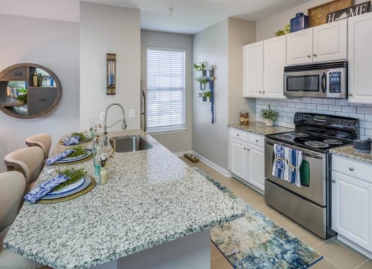 a kitchen with a counter top next to a stove top oven at Sterling Manor, Virginia
