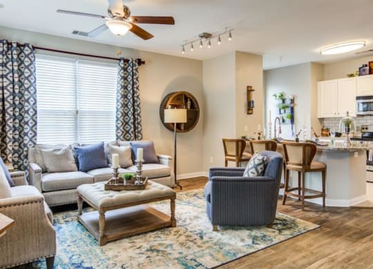 a living room with furniture and a kitchen in the background at Sterling Manor, Williamsburg, VA 23185