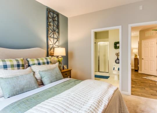 a bedroom with a bed and a door to a bathroom at Sterling Manor, Williamsburg, VA