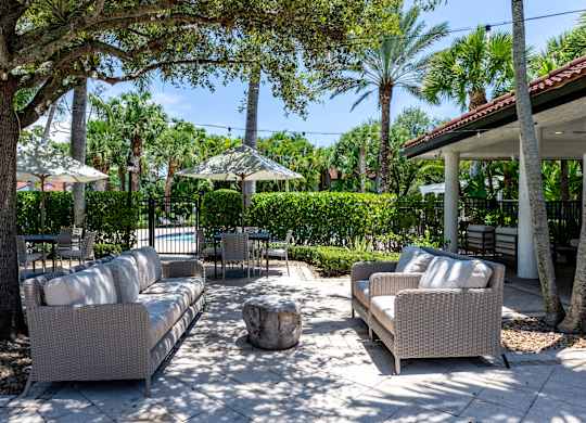 A patio with couches and trees.