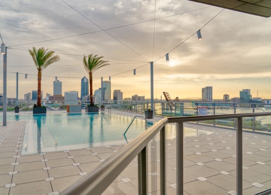the swimming pool on the roof of a building with the city skyline in the background at Vista Brooklynn Apartments, Florida