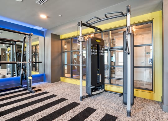 a gym with cardio machines and glass doors at Vista Brooklynn Apartments, Jacksonville