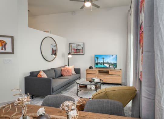 a living room with a couch and a tv at Vista Brooklynn Apartments, Jacksonville
