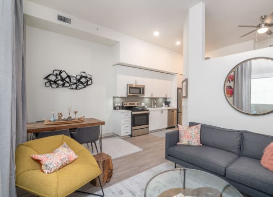 a living room with a couch and a table and a kitchen at Vista Brooklynn Apartments, Jacksonville, Florida