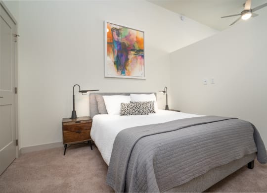 a bedroom with a bed and a painting on the wall at Vista Brooklynn Apartments, Florida