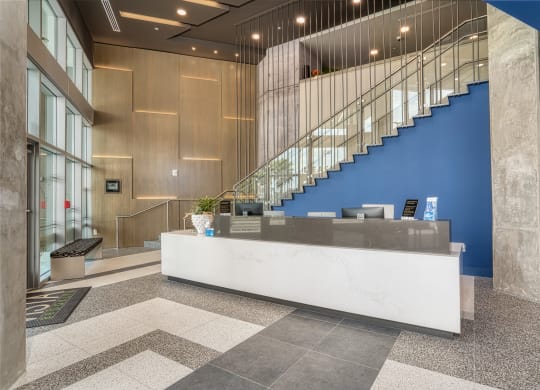a lobby with a reception desk and a spiral staircase at Vista Brooklynn Apartments, Jacksonville, 32202