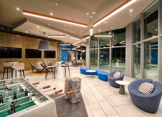 a lobby with tables and chairs and a pool at Vista Brooklynn Apartments, Jacksonville, Florida