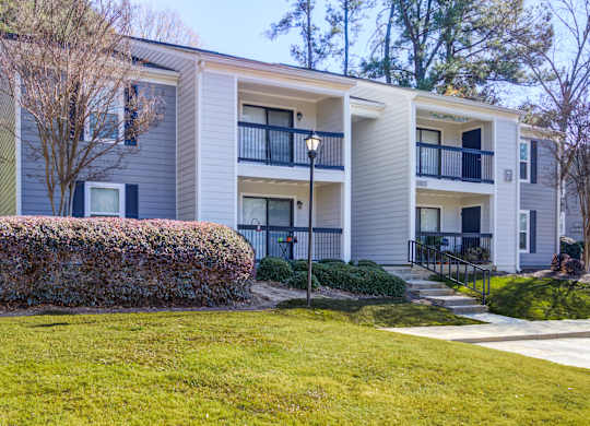 Apartment building with a green lawn in front.