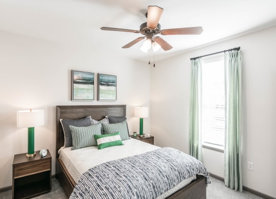 a bedroom with a bed and a ceiling fan at Village at Westland Cove Apartments, Knoxville, 37922