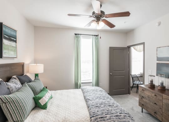 a bedroom with a bed and a ceiling fan at Village at Westland Cove Apartments, Tennessee, 37922