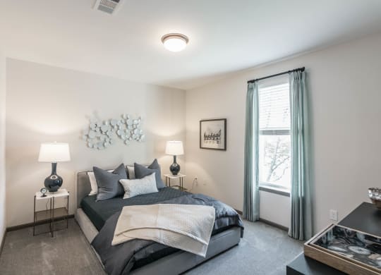 a bedroom with a large bed and a window at Village at Westland Cove Apartments, Tennessee