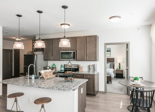 a kitchen and dining area with a marble counter top at Village at Westland Cove Apartments, Tennessee
