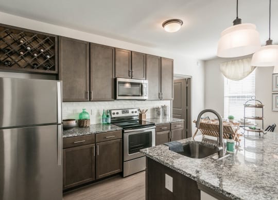 a kitchen with stainless steel appliances and granite counter tops at Village at Westland Cove Apartments, Knoxville, TN, 37922