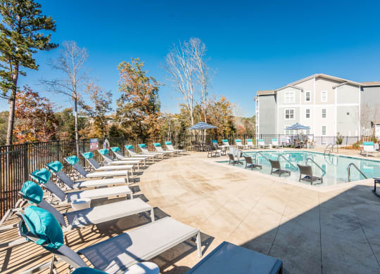 our apartments have a resort style pool with lounge chairs at Village at Westland Cove Apartments, Knoxville, TN, 37922