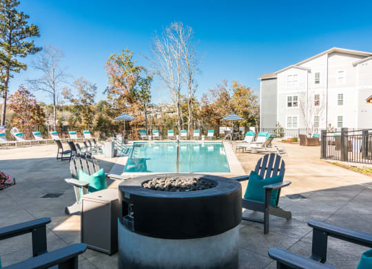 our apartments have a resort style pool and lounge area with chairs at Village at Westland Cove Apartments, Tennessee