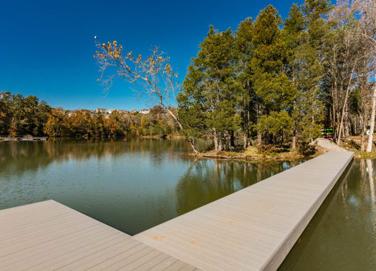 a dock on a lake with trees in the background at Village at Westland Cove Apartments, Knoxville, 37922