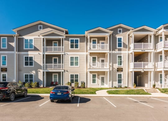 an apartment building with cars parked in front of it at Village at Westland Cove Apartments, Knoxville, 37922