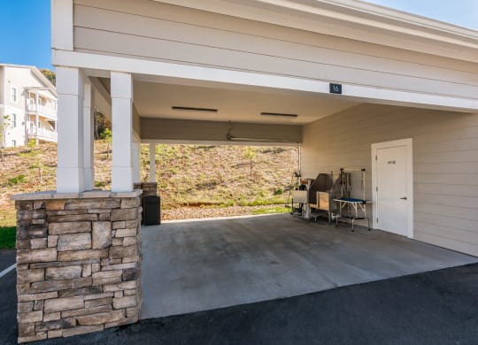 a covered porch with a door and a table on it at Village at Westland Cove Apartments, Tennessee