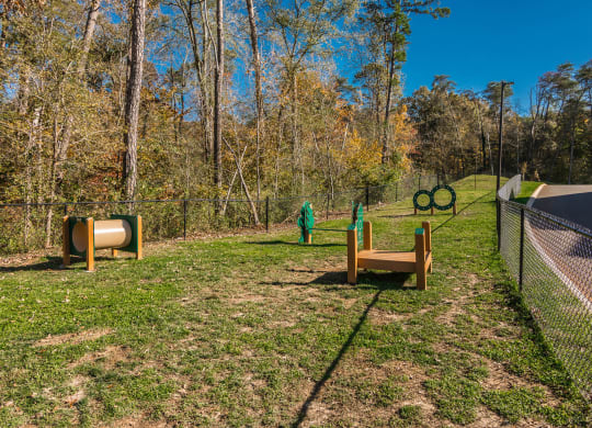a dog park with agility equipment and a fence at Village at Westland Cove Apartments, Tennessee