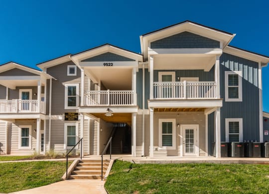 an apartment building with stairs and a sidewalk in front of it at Village at Westland Cove Apartments, Knoxville, TN