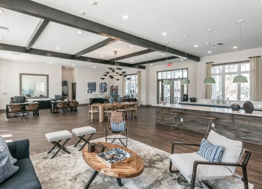 a living room with furniture and a bar and a dining room at Village at Westland Cove Apartments, Knoxville