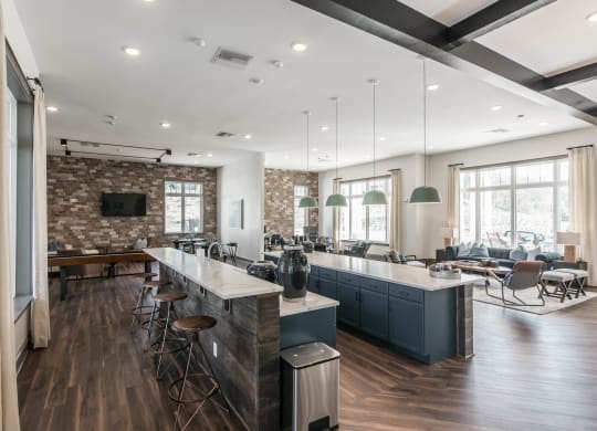 a large kitchen with a bar and a living room at Village at Westland Cove Apartments, Knoxville