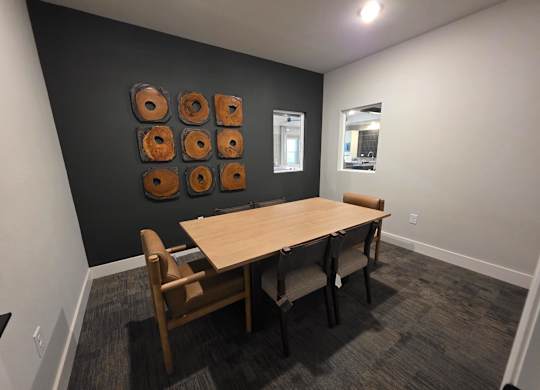 A conference room with a table and chairs.