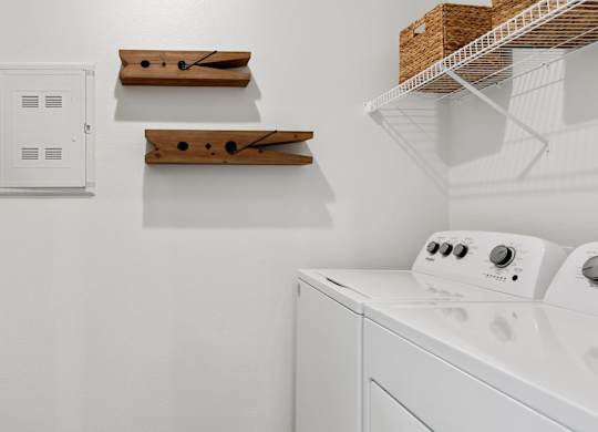 A white dryer is sitting in a laundry room.