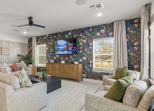 A living room with a sofa, a chair, and a television.