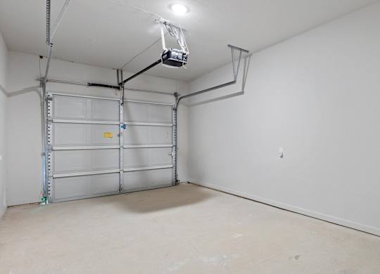 A white wall with a shelving unit and a light fixture.