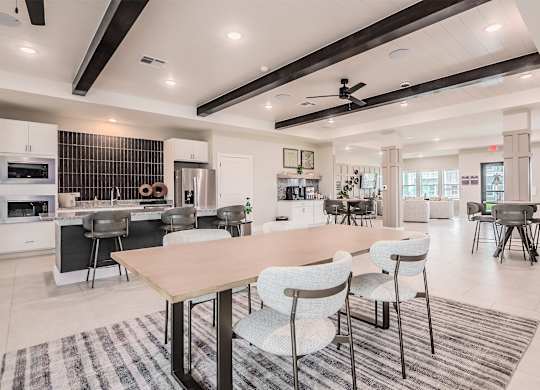A modern kitchen with a dining table and chairs.