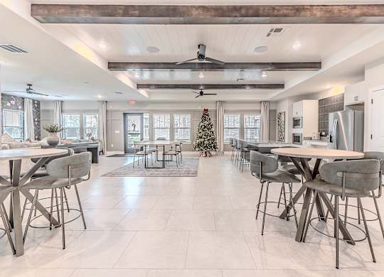 A modern dining room with a Christmas tree in the middle.