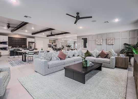 A modern living room with a grey sofa set and a black coffee table.