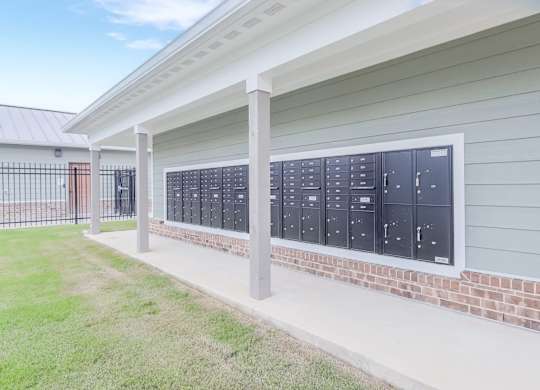 A row of mailboxes are on the side of a building.