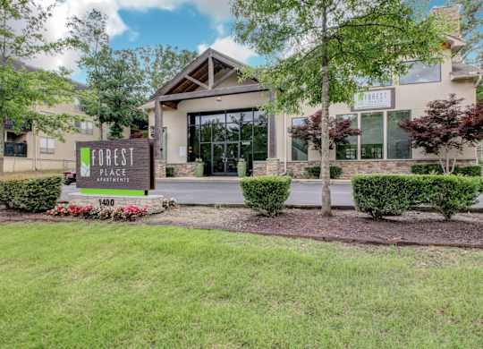 The front of the Forest Apartments building with a sign that says 1400.