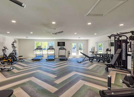 A spacious gym with a variety of exercise equipment.