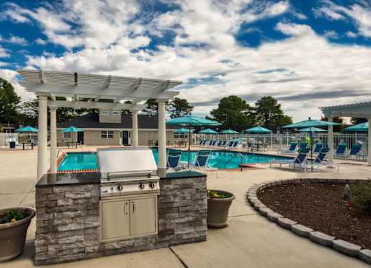 A poolside area with a stone structure and a hot tub.