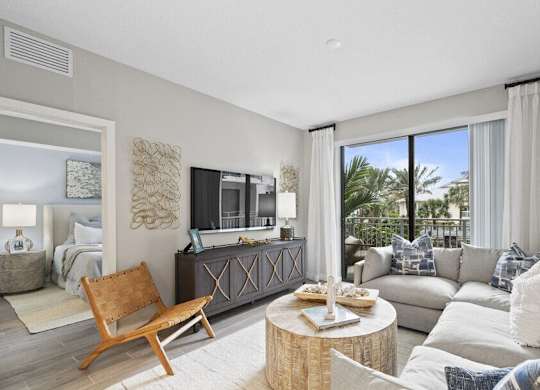 a living room with a couch and a tv at Mayla Pompano, Pompano Beach, FL