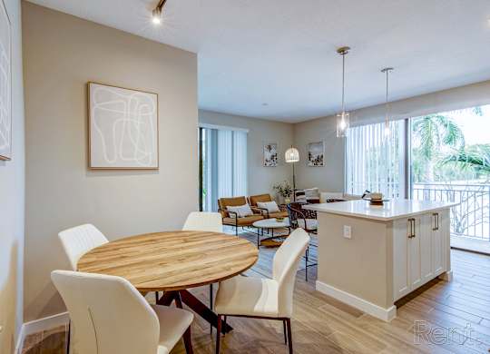 A dining room with a wooden table and chairs.