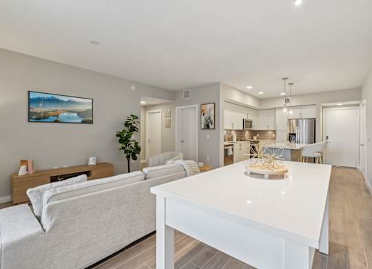 A modern living room with a white couch and a white coffee table.