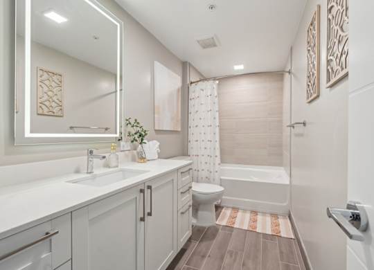 A bathroom with a white sink and a white bathtub.