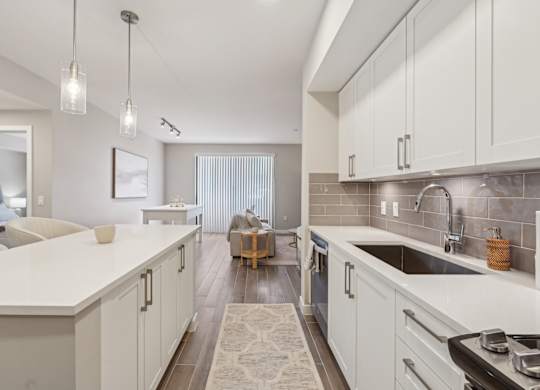 A modern kitchen with white cabinets and a large island.