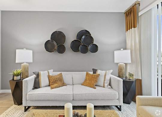 a living room with a couch and pots on the wall